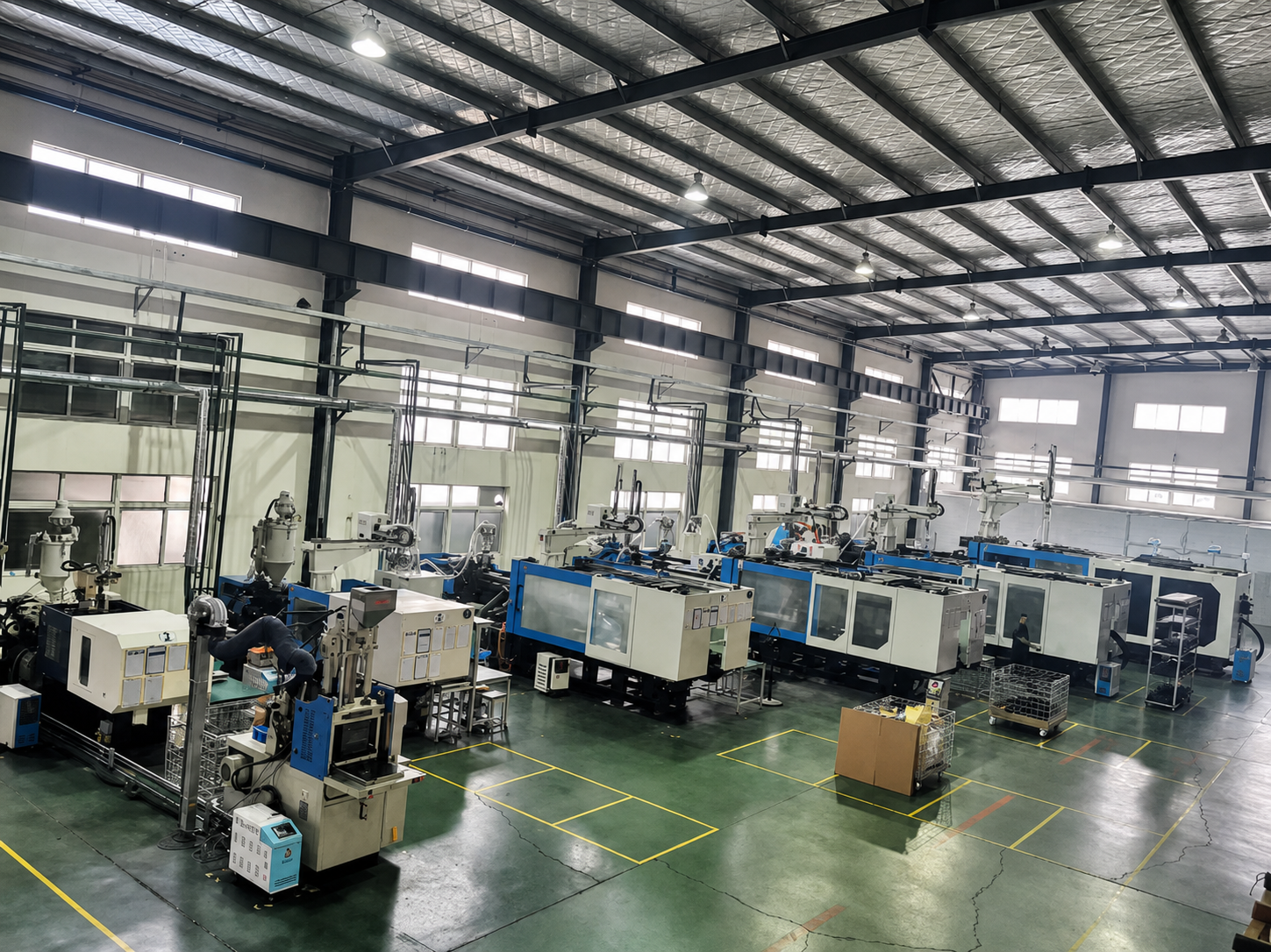 ACXTA injection-molding workshop with rows of machines