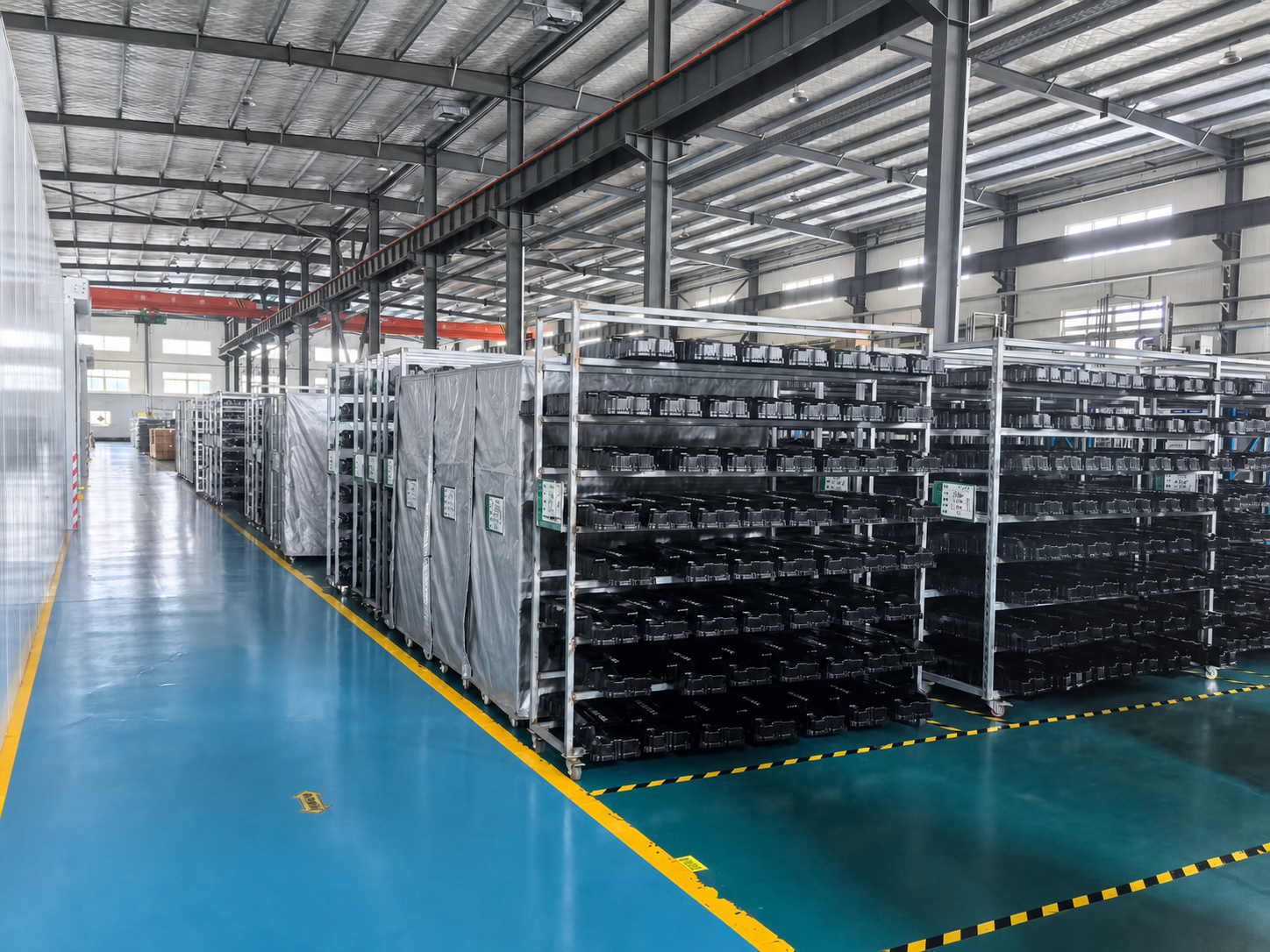 ACXTA warehouse racks holding finished black plastic parts